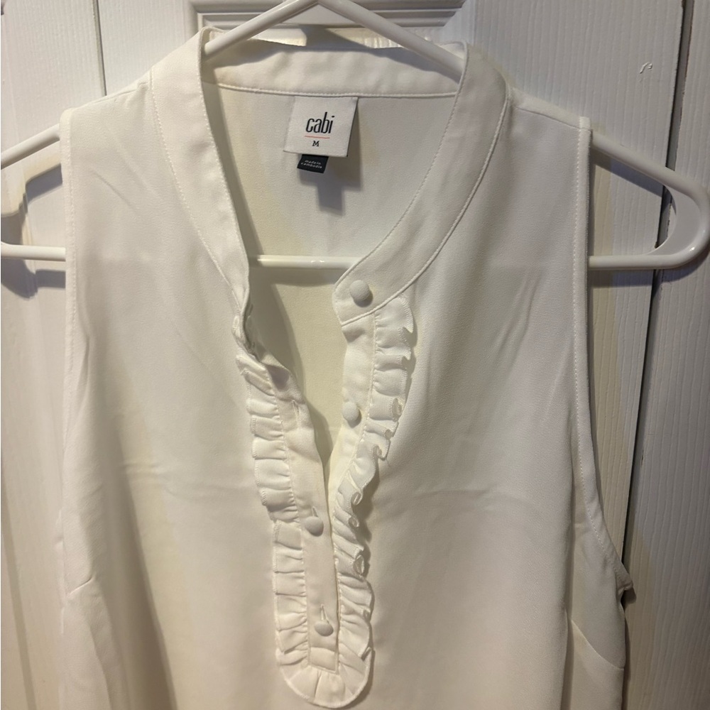 White sheer sleeveless ruffle cabi blouse.